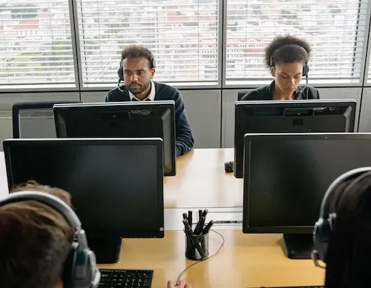man and woman looking at computer