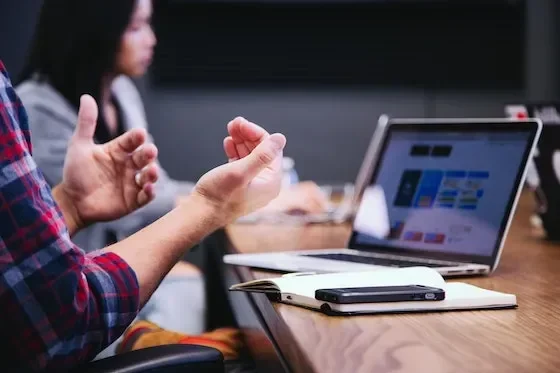 man explaining something from computer