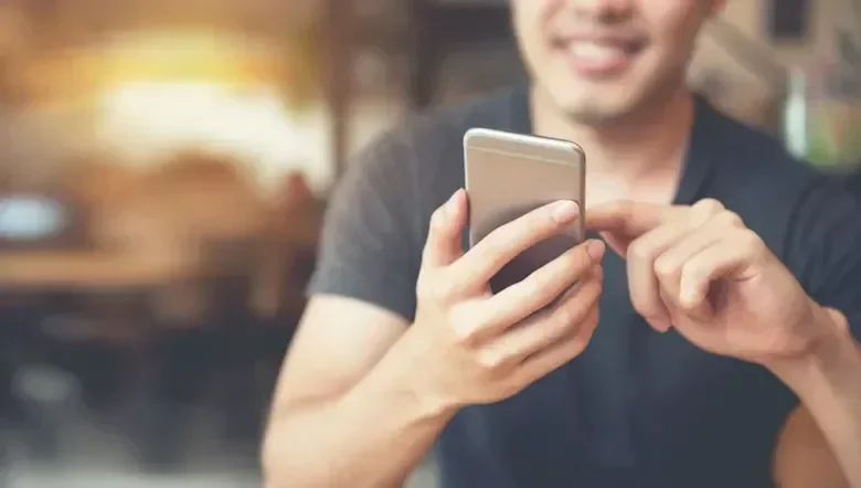 Man using phone and smiling